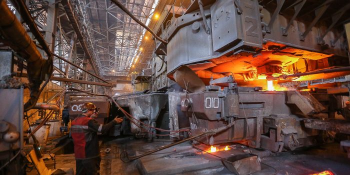 Workers of Azov Stal Plant, one of the largest metal producers in Mariupol owned by Metinvest Group, monitor the metal smelting process at one of the processing areas of the plant in July 2017.