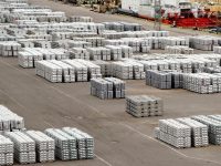 Packages of metal lying on each other on stack at the berth are ready for loading on the ship