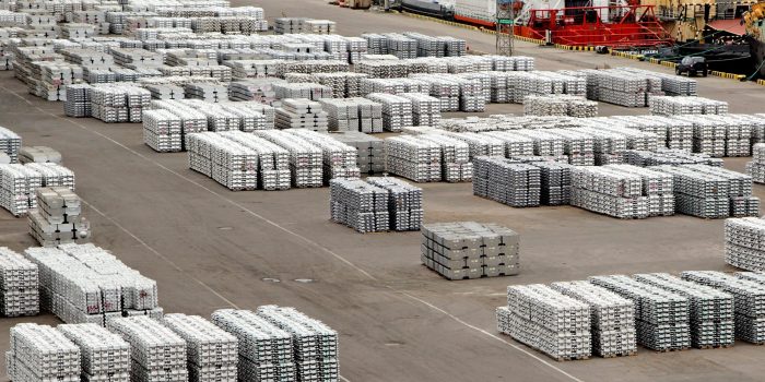 Packages of metal lying on each other on stack at the berth are ready for loading on the ship