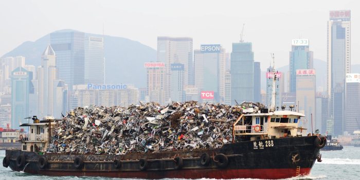 Hong Kong, China - October 8, 2012: Garbage being hauled on boat in Victoria Harbor. The dense population means its existing landfills are expected to be full by 2015.