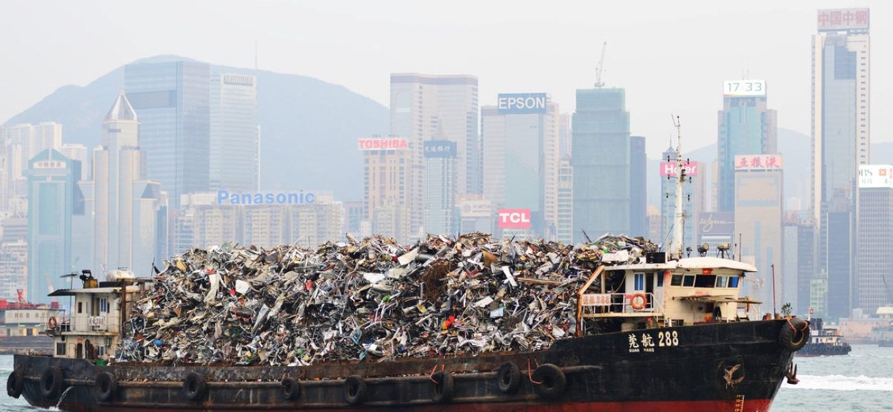 Hong Kong, China - October 8, 2012: Garbage being hauled on boat in Victoria Harbor. The dense population means its existing landfills are expected to be full by 2015.