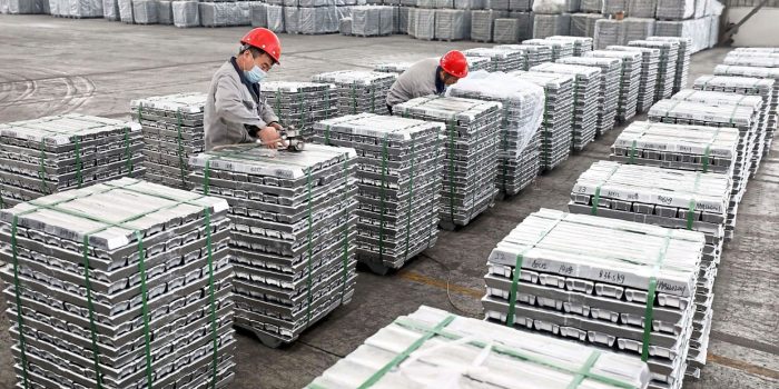 Employees work with aluminium ingots at a factory in Huaibei in China's eastern Anhui province on February 9, 2022. (Photo by AFP) / China OUT
