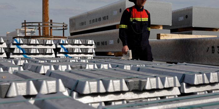 FILE PHOTO: A worker walks past the storage of aluminium ingots at the aluminum smelter Aluminium Dunkerque in Loon-Plage near Dunkirk, France, September 22, 2022. REUTERS/Pascal Rossignol