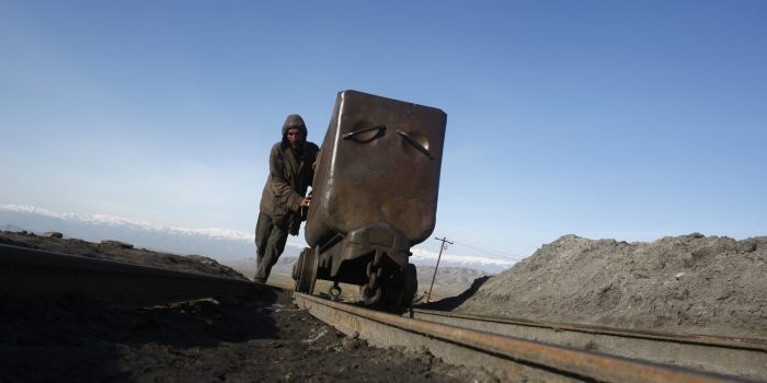 FILE PHOTO: An Afghan miner pushes a wagon at the Karkar coal mine in Pul-i-Kumri, about 170km north of Kabul, March 8, 2009.   REUTERS/Ahmad Masood