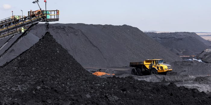 FILE PHOTO: A truck drives past a conveyor pouring coal produced at Canyon Coal's Khanye colliery near Bronkhorstspruit, around 90 kilometres north-east of Johannesburg, South Africa, April 26, 2022. Picture taken April 26,2022. REUTERS/Siphiwe Sibeko/File Photo