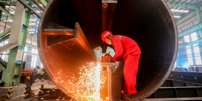 A man works at a production base of China Construction Steel Structure Corp Ltd (CSCEC Steel) in Meishan, Sichuan province, China September 3, 2019. Picture taken September 3, 2019. REUTERS/Stringer  ATTENTION EDITORS - THIS IMAGE WAS PROVIDED BY A THIRD PARTY. CHINA OUT. - RC16D3CE80E0