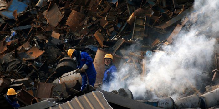 FILE PHOTO: Workers dismantle scrap metal at a steel plant in Huaian, Jiangsu province, China March 4, 2019.  REUTERS/Stringer/File Photo