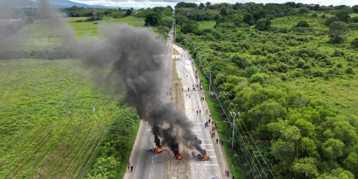 Aerial view of demonstrators blocking a road as they clash with riot police during a protest against the contract for the Canadian mining company FQM in Panama City, taken on October 23, 2023. The National Assembly of Panama approved a bill with Minera Panama, a subsidiary of Canadian First Quantum Minerals (FQM), to exploit the largest open-pit copper mine in Central America, while protests continue in rejection of that controversial pact. (Photo by Luis ACOSTA / AFP) (Photo by LUIS ACOSTA/AFP via Getty Images)