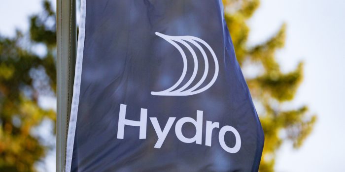 Norwegian aluminium group Norsk Hydro new logo can be seen on a flag at their headquarters at Lysaker outside of Oslo, Norway on October 3, 2018. - Norsk Hydro said it will suspend production at the world's largest alumina plant in Brazil as it had not received authorisation to use a new waste deposit area. (Photo by Fredrik HAGEN / NTB Scanpix / AFP) / Norway OUT (Photo by FREDRIK HAGEN/NTB Scanpix/AFP via Getty Images)
