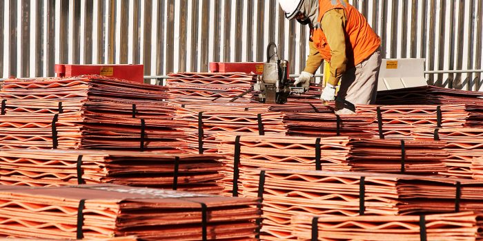Worker Securing Copper Cathodes Packs in Escondida Chile. (Photo by Oliver Llaneza Hesse/Construction Photography/Avalon/Getty Images)